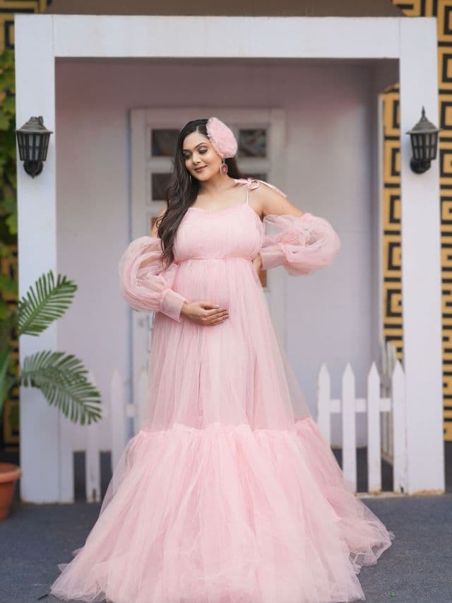 enchanted rose maternity gown on an expecting mom, studio portrait.