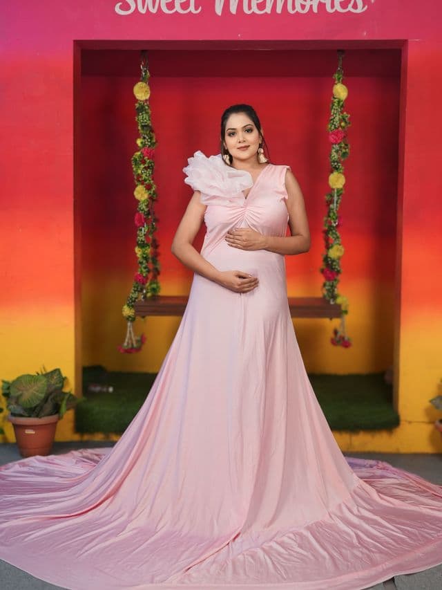 petal princess maternity gown on an expecting mom, studio portrait.